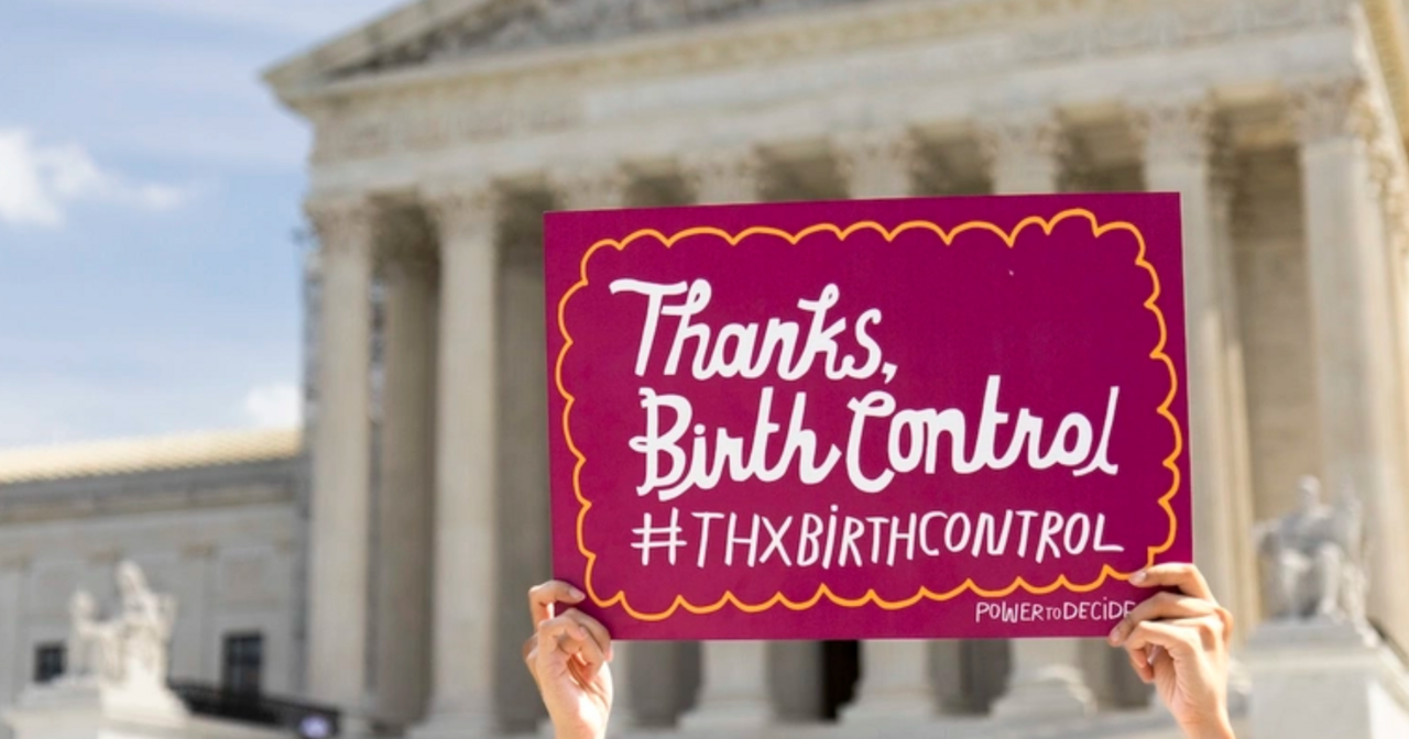 Hands holding up a Thanks, Birth Control sign in front of the supreme court
