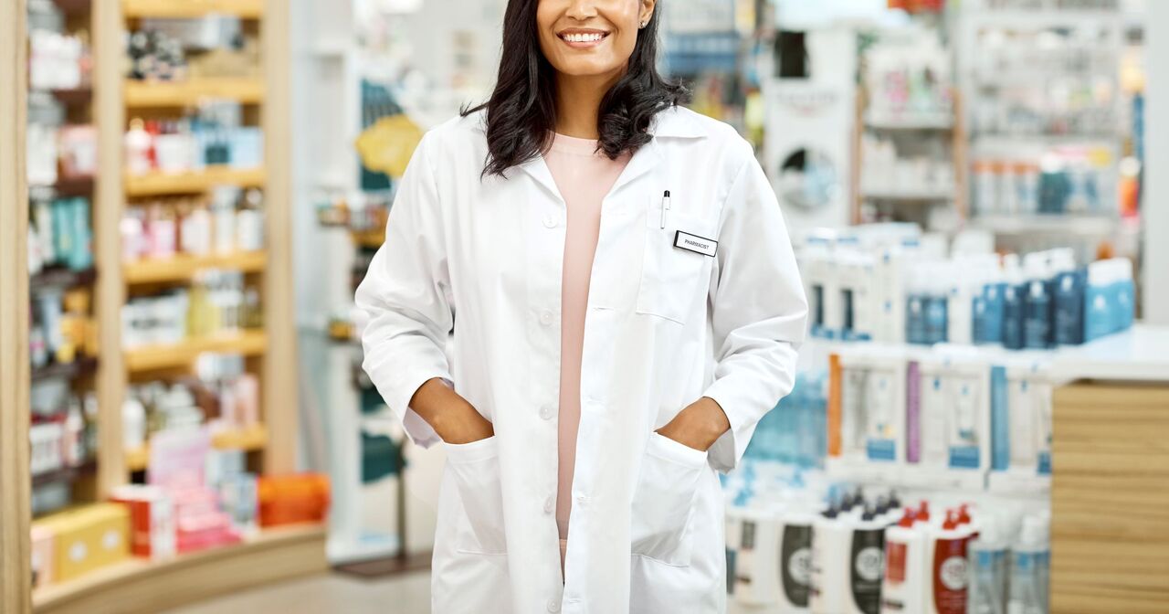 Smiling pharmacist standing in a pharmacy
