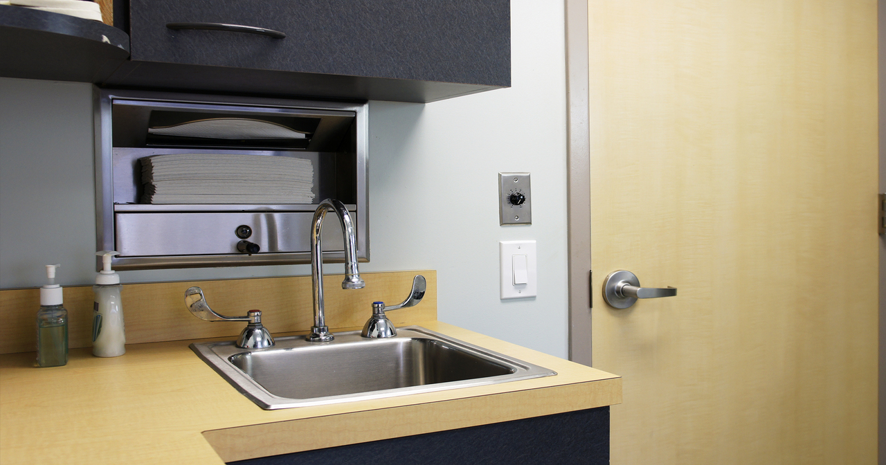 Sink with soap and paper towels in a doctor's office