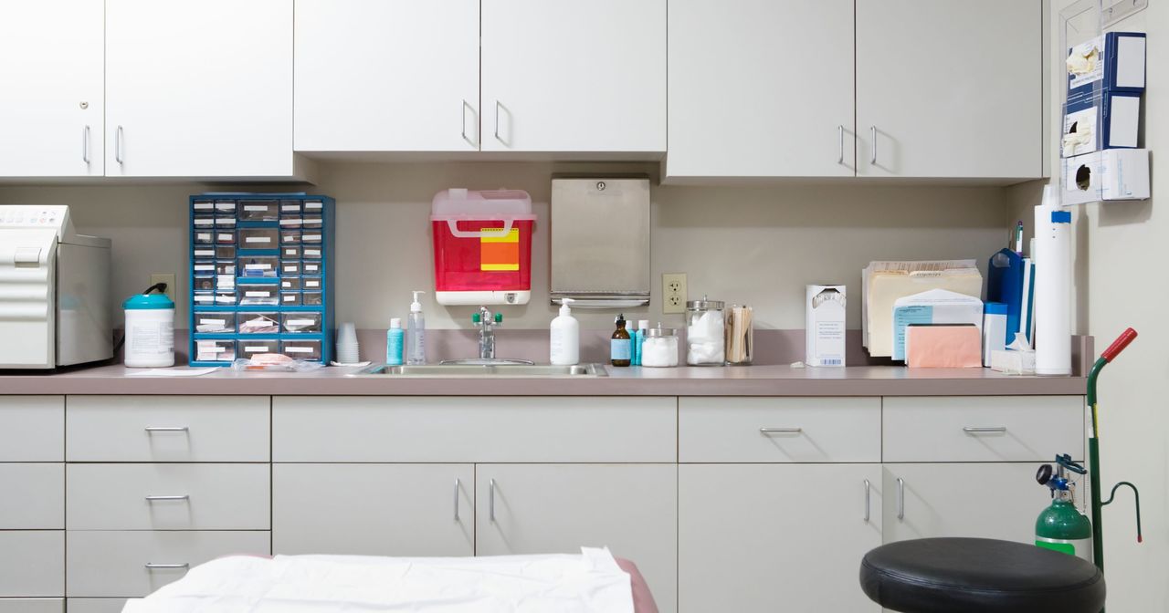 Counter and sink in a clean exam room, viewed from the exam table