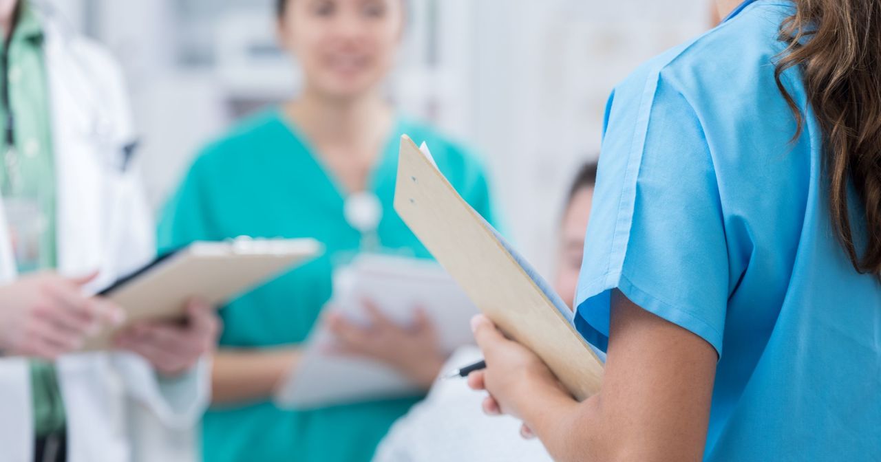 A doctor having a meeting with other providers and nurses
