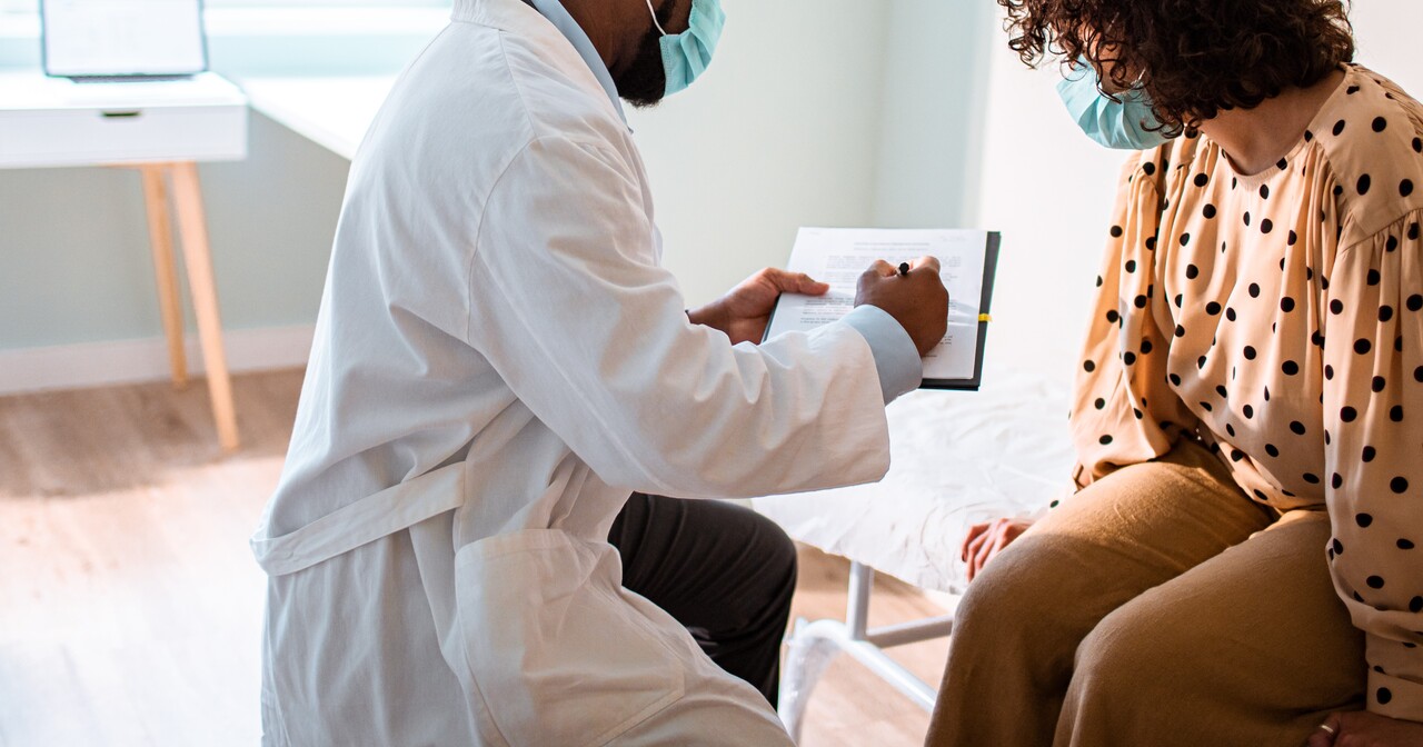Doctor going over paperwork with a female patient in office