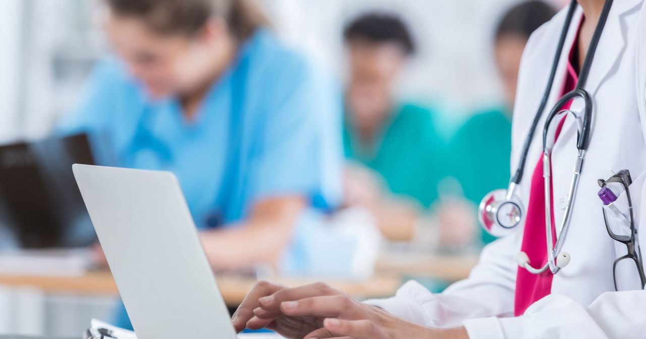 A provider typing on her laptop