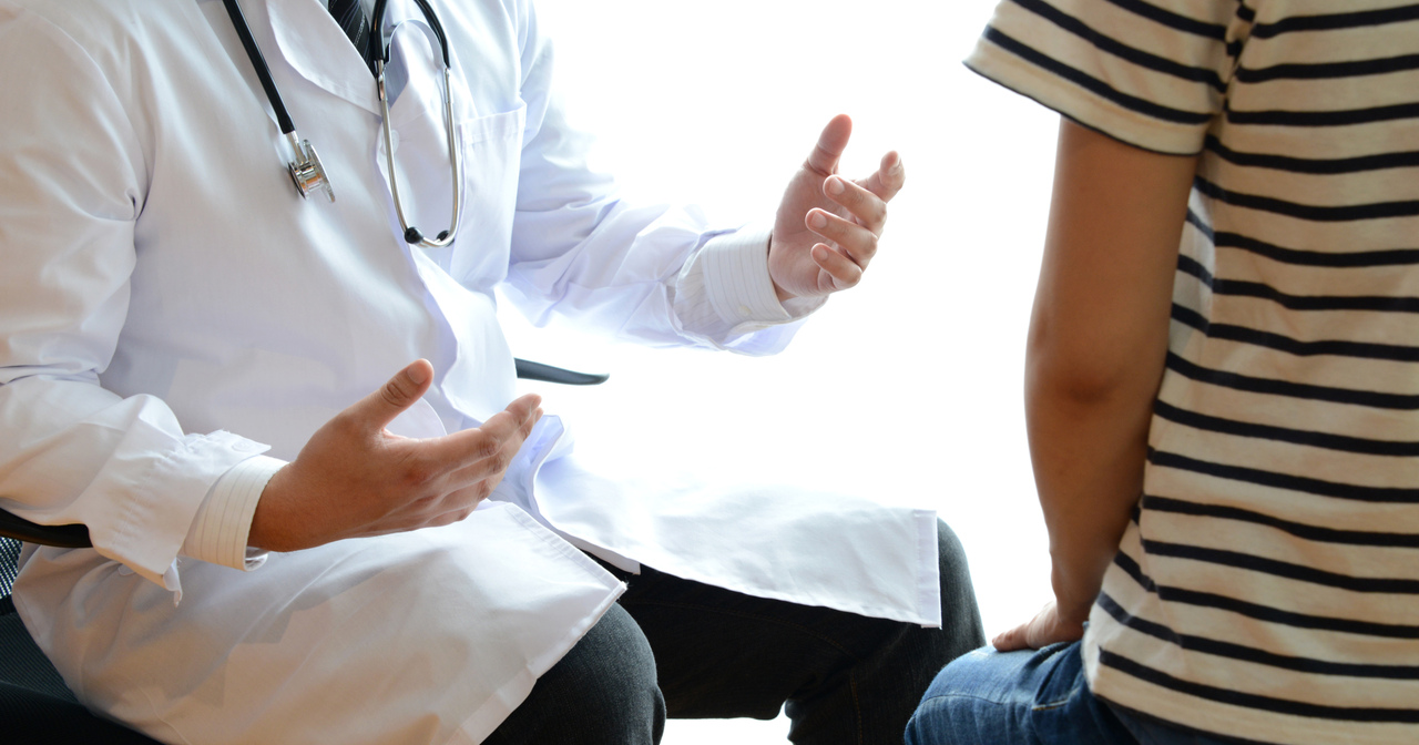 Close up of doctor using his hands while speaking to a patient
