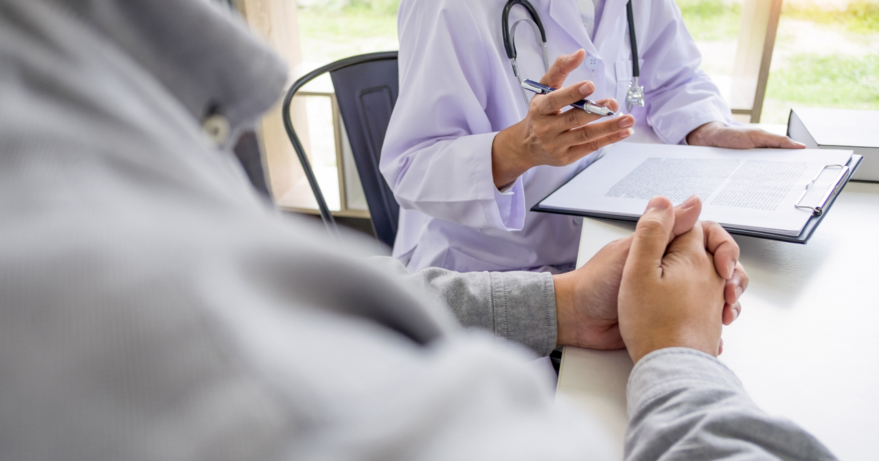 A provider going over intake paperwork with a patient