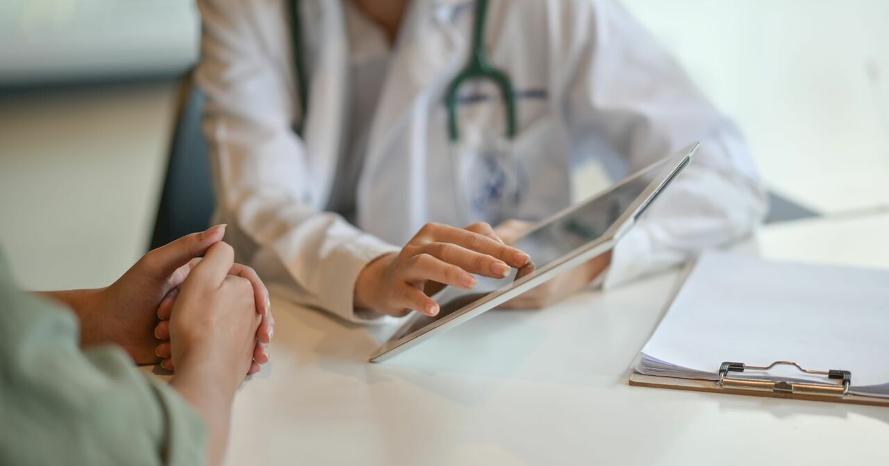 A provider showing a patient something on her digital tablet